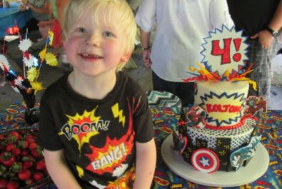 boy with a super hero cake