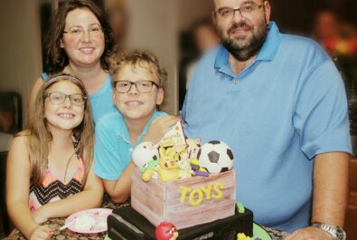 family around a toy cake