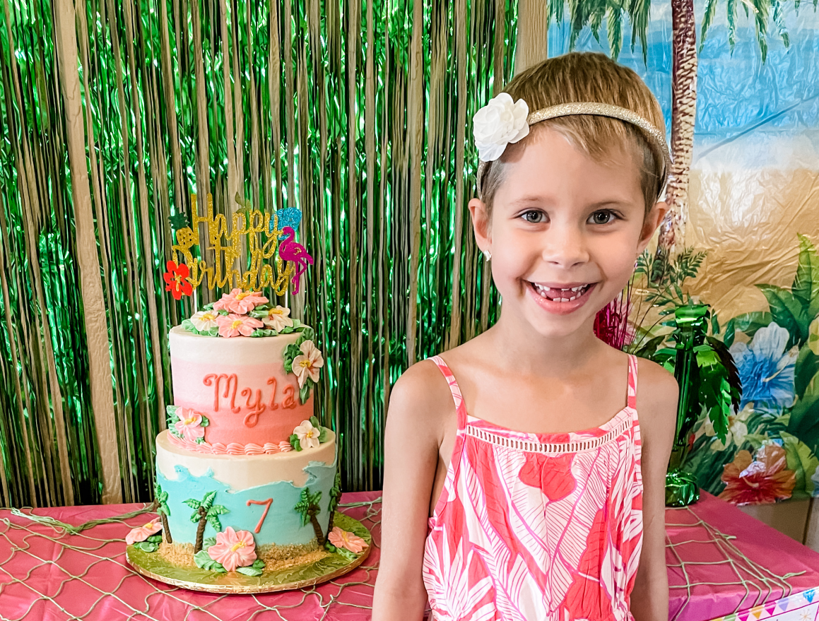 girl smiling with a birthday cake