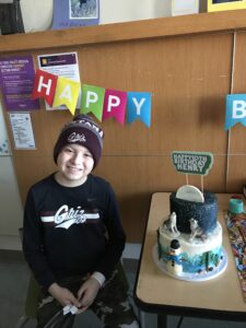 boy celebrating birthday with a cake
