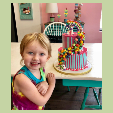 Madison smiling with a cake