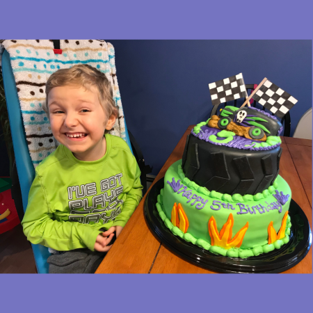 boy with a race car cake