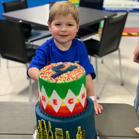 Breck behind a big cake