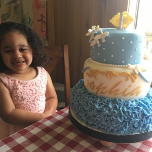 Sophia next to a cake