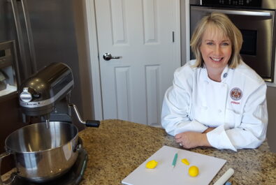 chef with a mixer and cutting board