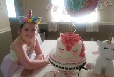 girl with a unicorn cake