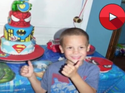 boy with a super hero cake