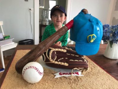 kid looking at a baseball cake