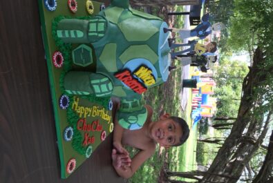 boy at a part with a turtle cake