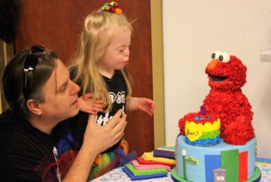 girl and man with sesame street cake