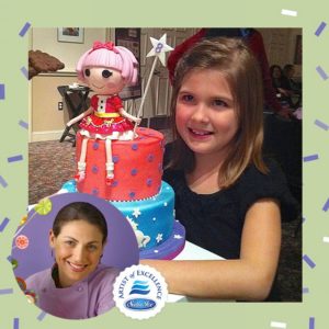 girl holding a custom fairy cake