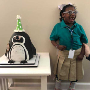 girl with penguin cake