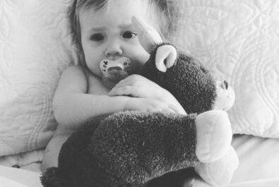 baby with a stuffed deer