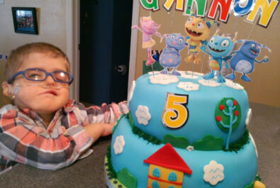 kid with a custom cake