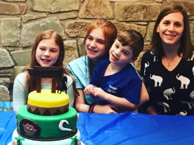 Jacob's family at a table with a custom cake