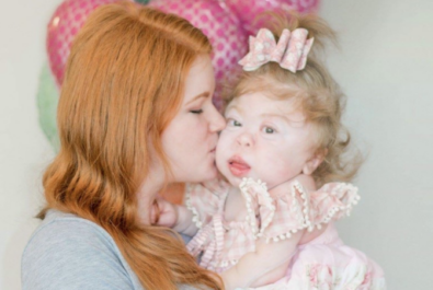 mother with daughter in front of balloons