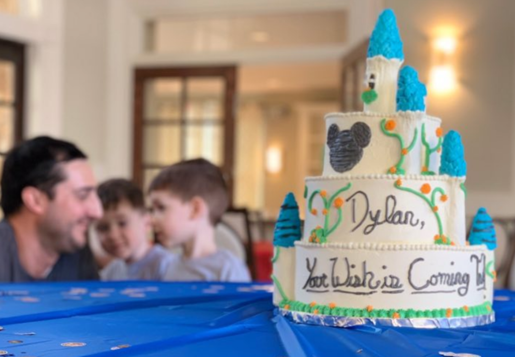 custom disney cake with family in the background