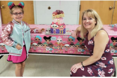 mother and daughter next to a cake