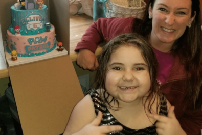 girl and mother with a paw patrol cake