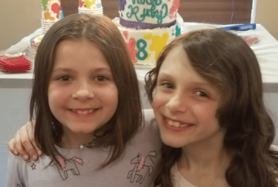 kids in front of a custom cake