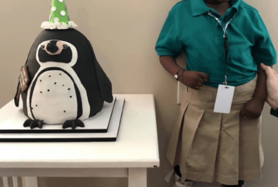 girl with a penguin cake