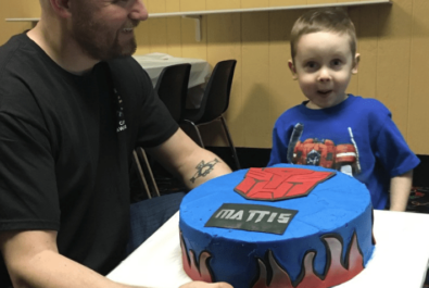 boy being presented a transformers cake