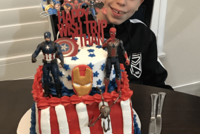 boy with a super hero cake