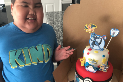 boy with a pokemon cake