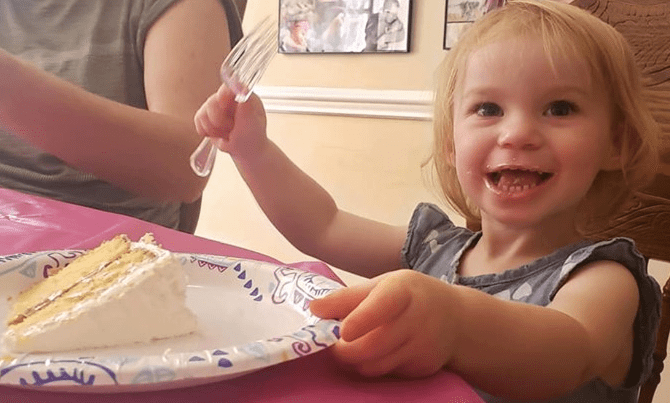 girl with a slice of cake