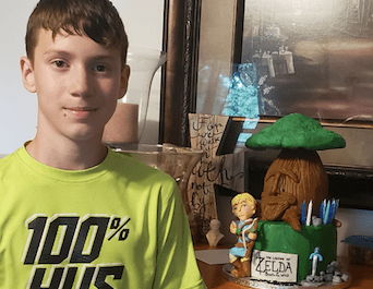 boy with a legend of zelda cake