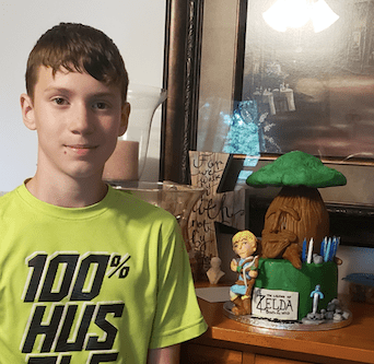 boy with a legend of zelda cake