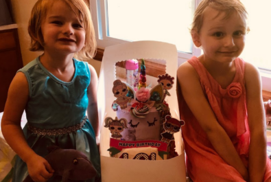 girls with a custom cake