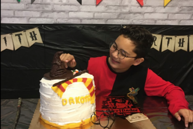 boy with a harry potter cake