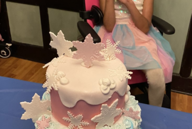 girl with a custom snow cake