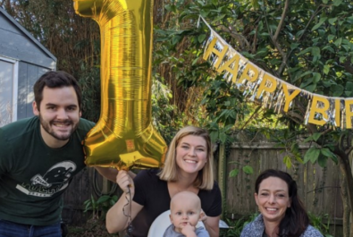 baby and family celebrating first birthday
