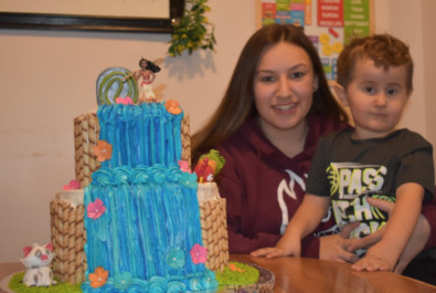 son and mother with a moana cake