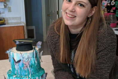 girl with a graduation cake