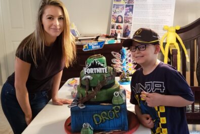 boy and woman with a Fortnite cake