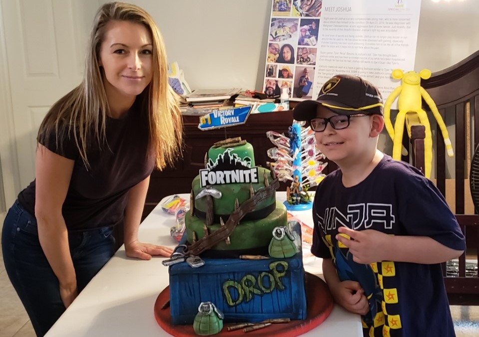 boy and woman with a Fortnite cake